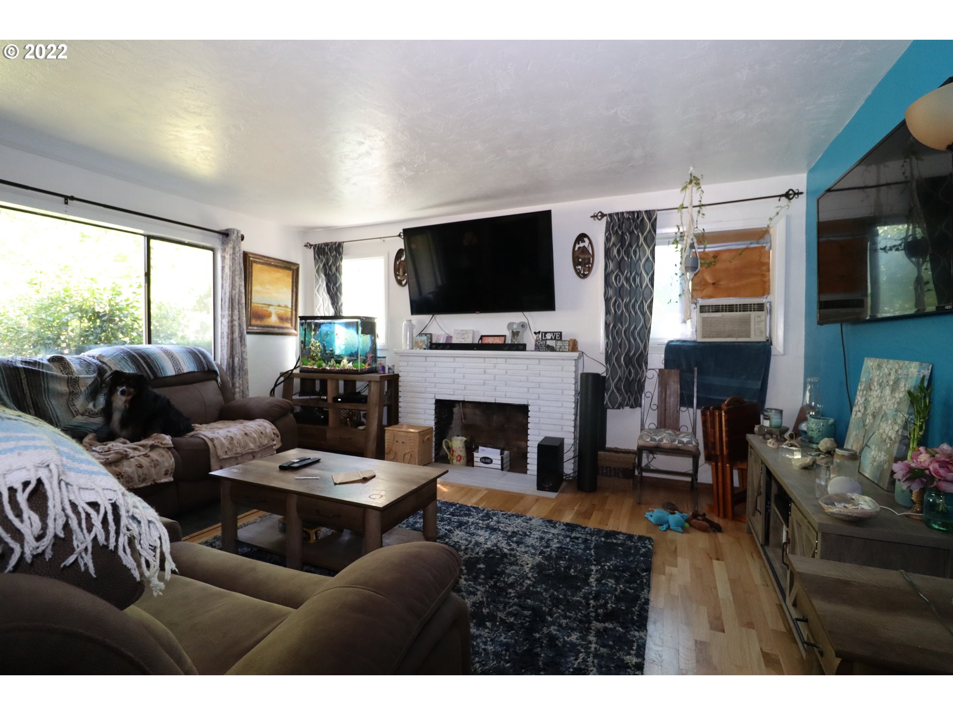 866 58th Street Springfield, OR 97478 - Photo 4 of 12 a living room with furniture a flat screen tv and a fireplace