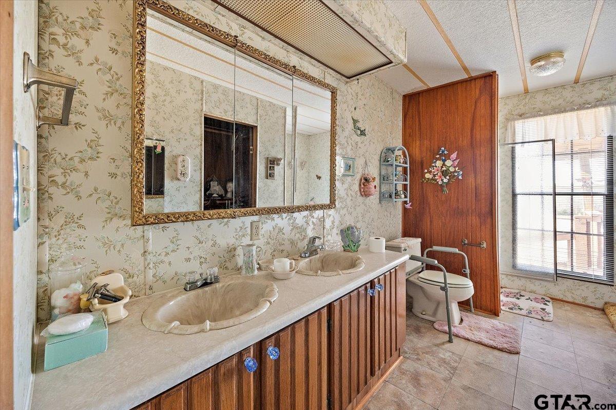 304 County Road 2206 Rusk, TX 75785 - Photo 14 of 27 a bathroom with a sink double vanity and a mirror