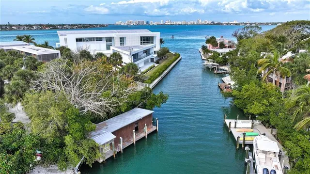 an aerial view of a house with outdoor space and lake view