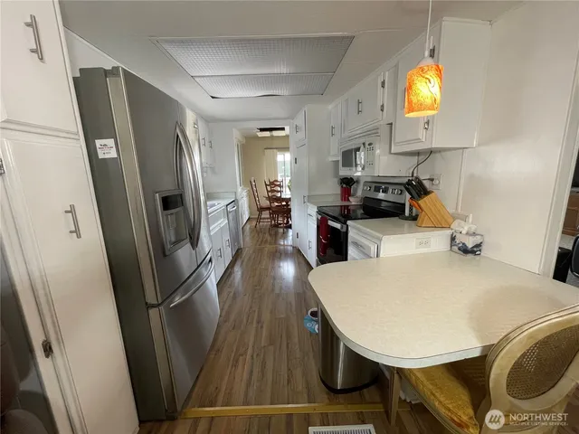 a view of kitchen with furniture and stainless steel appliances
