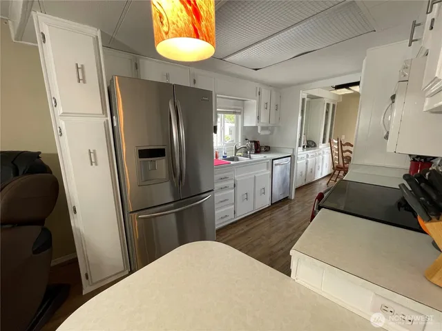 a kitchen with stainless steel appliances a refrigerator sink and cabinets