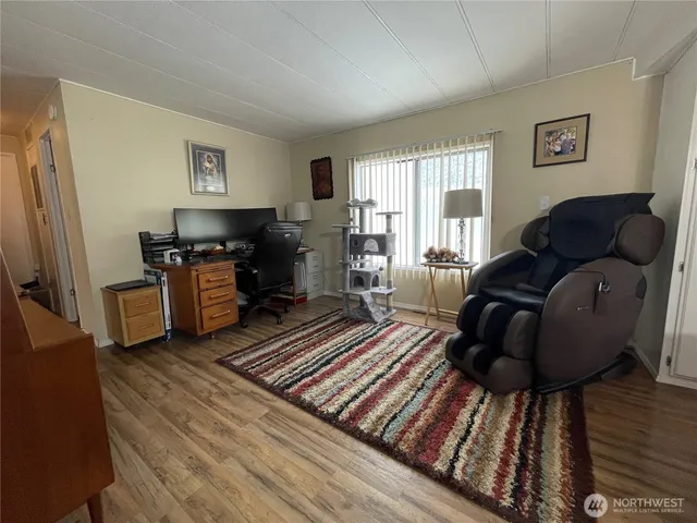 a living room with furniture a fireplace and a window