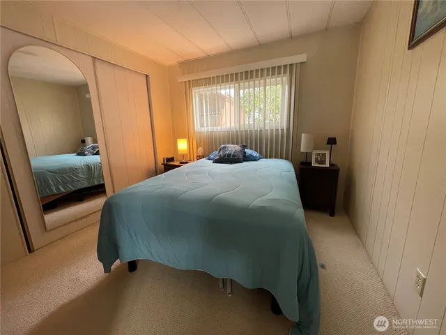 a bedroom with a bed and window