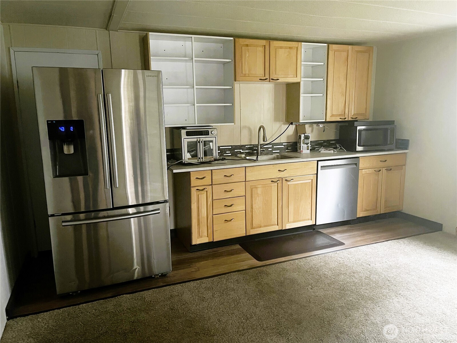 2101 South 324th Street, Unit 21 Federal Way, WA 98003 - Photo 23 of 39 a kitchen with stainless steel appliances granite countertop a refrigerator and a sink