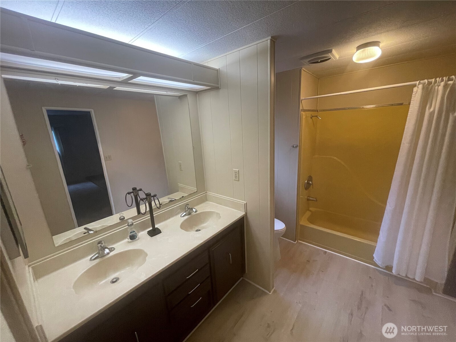 2101 South 324th Street, Unit 21 Federal Way, WA 98003 - Photo 28 of 40 a bathroom with a double vanity sink a large mirror and shower