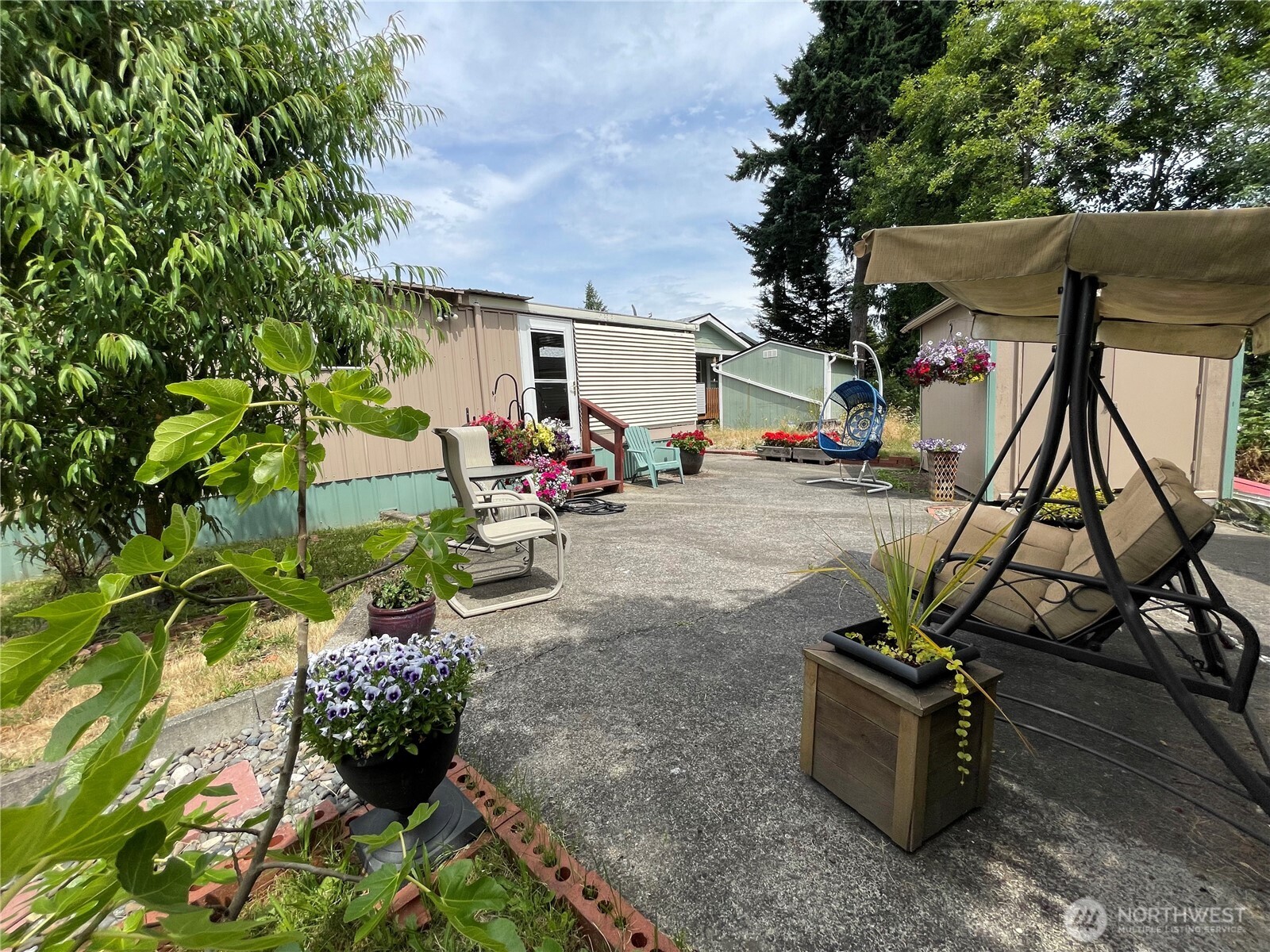 2101 South 324th Street, Unit 21 Federal Way, WA 98003 - Photo 5 of 39 a view of a backyard with chairs and potted plants