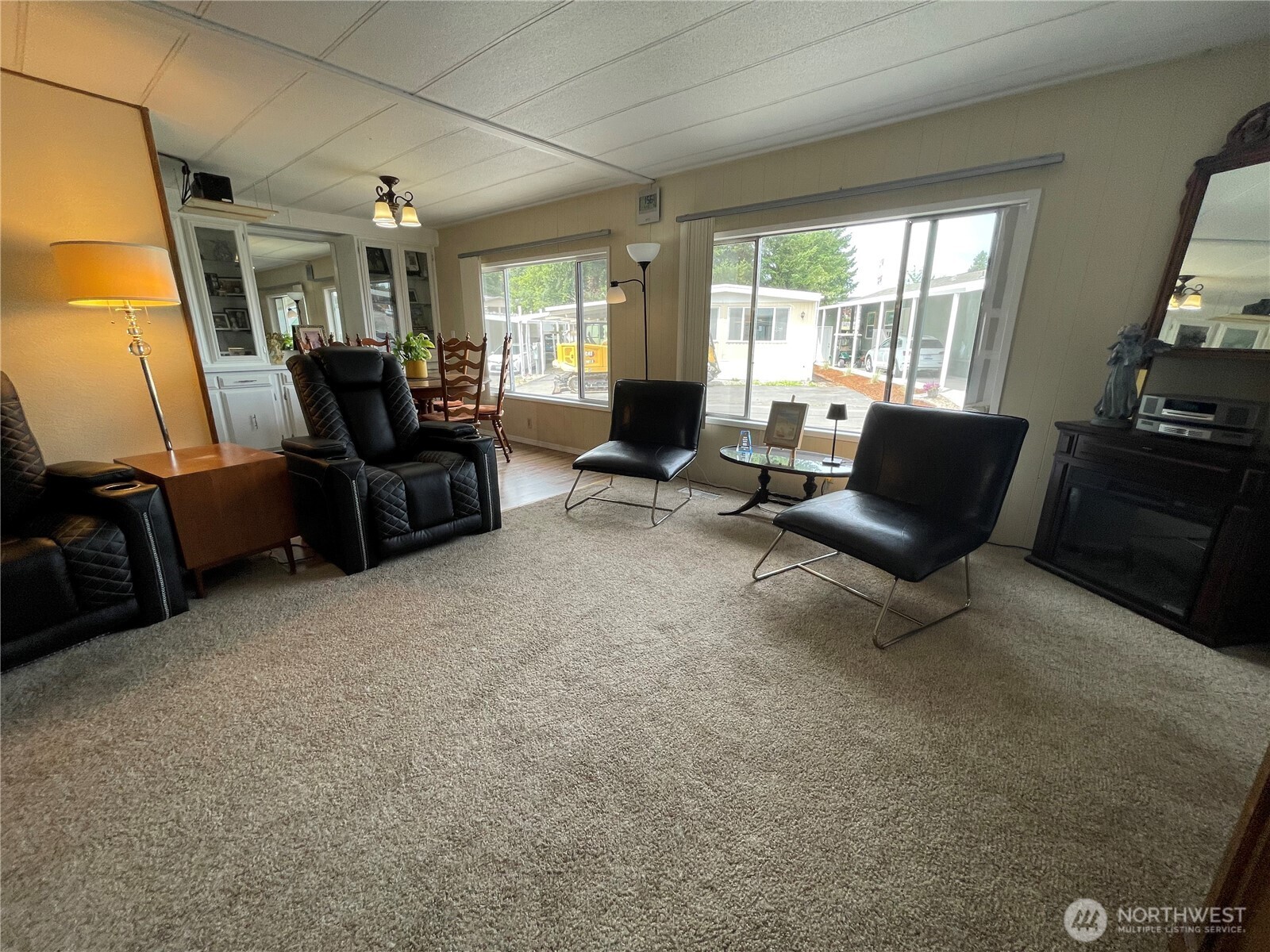 2101 South 324th Street, Unit 21 Federal Way, WA 98003 - Photo 8 of 39 a living room with furniture and a flat screen tv
