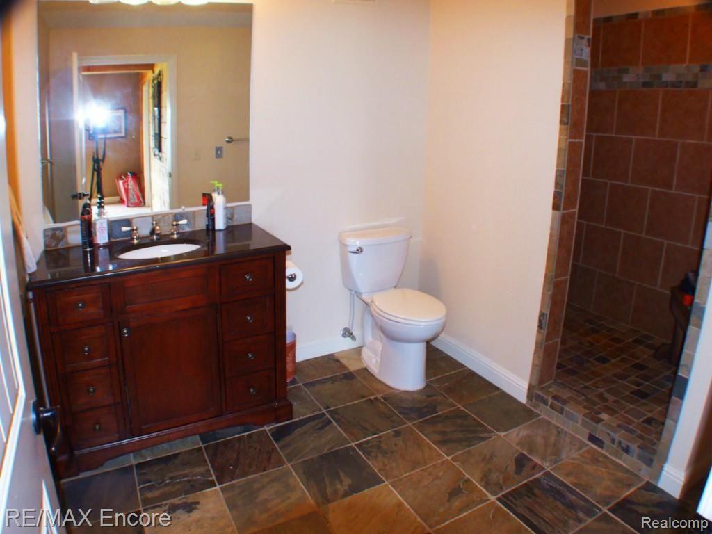 8363 Henderson Road Goodrich, MI 48438 - Photo 29 of 44 Full bath in lower level with travertine tile and walk-in shower