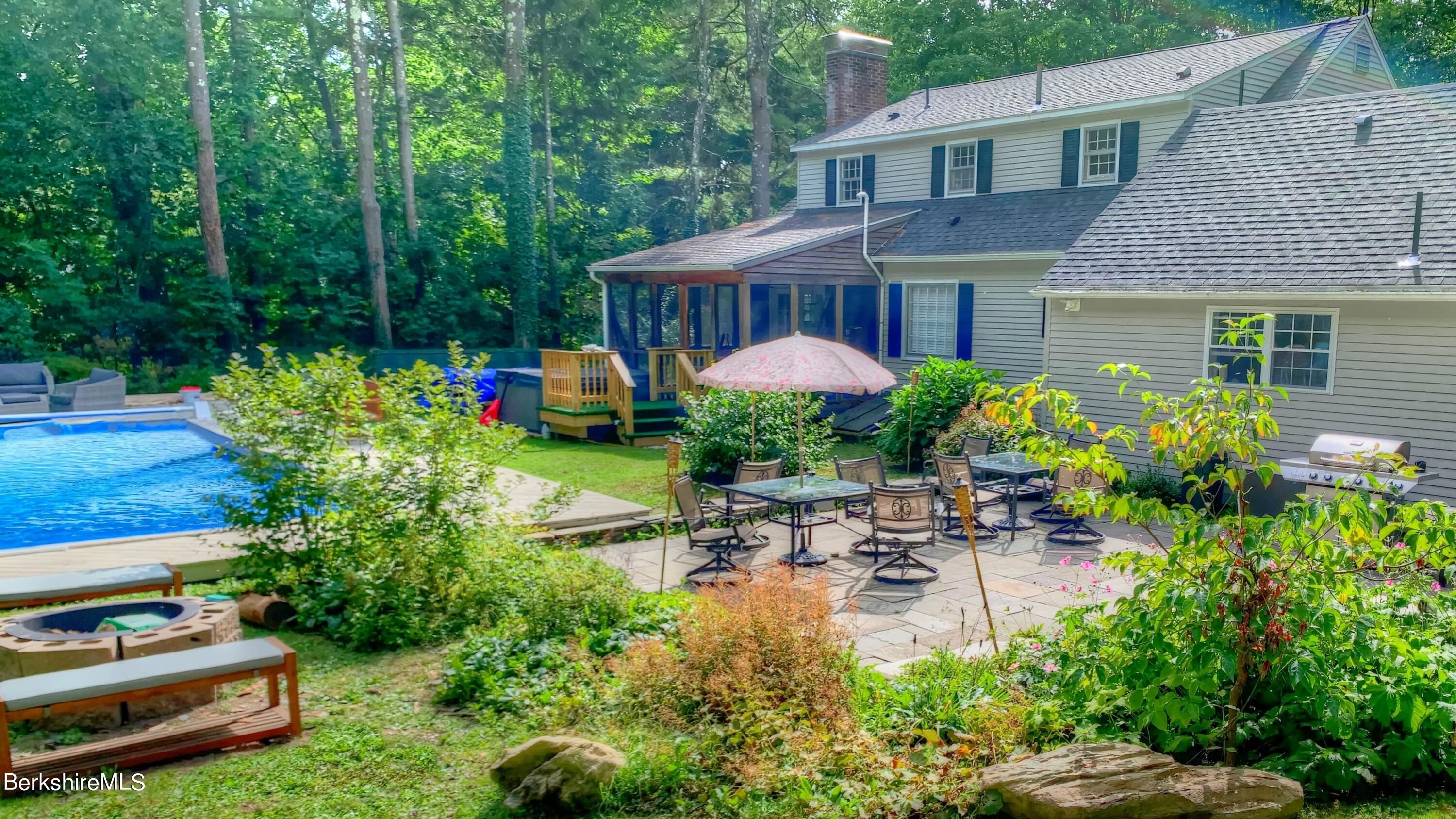 7 Hawthorne Road Stockbridge, MA 01262 - Photo 11 of 41 a front view of a house with a garden and sitting area