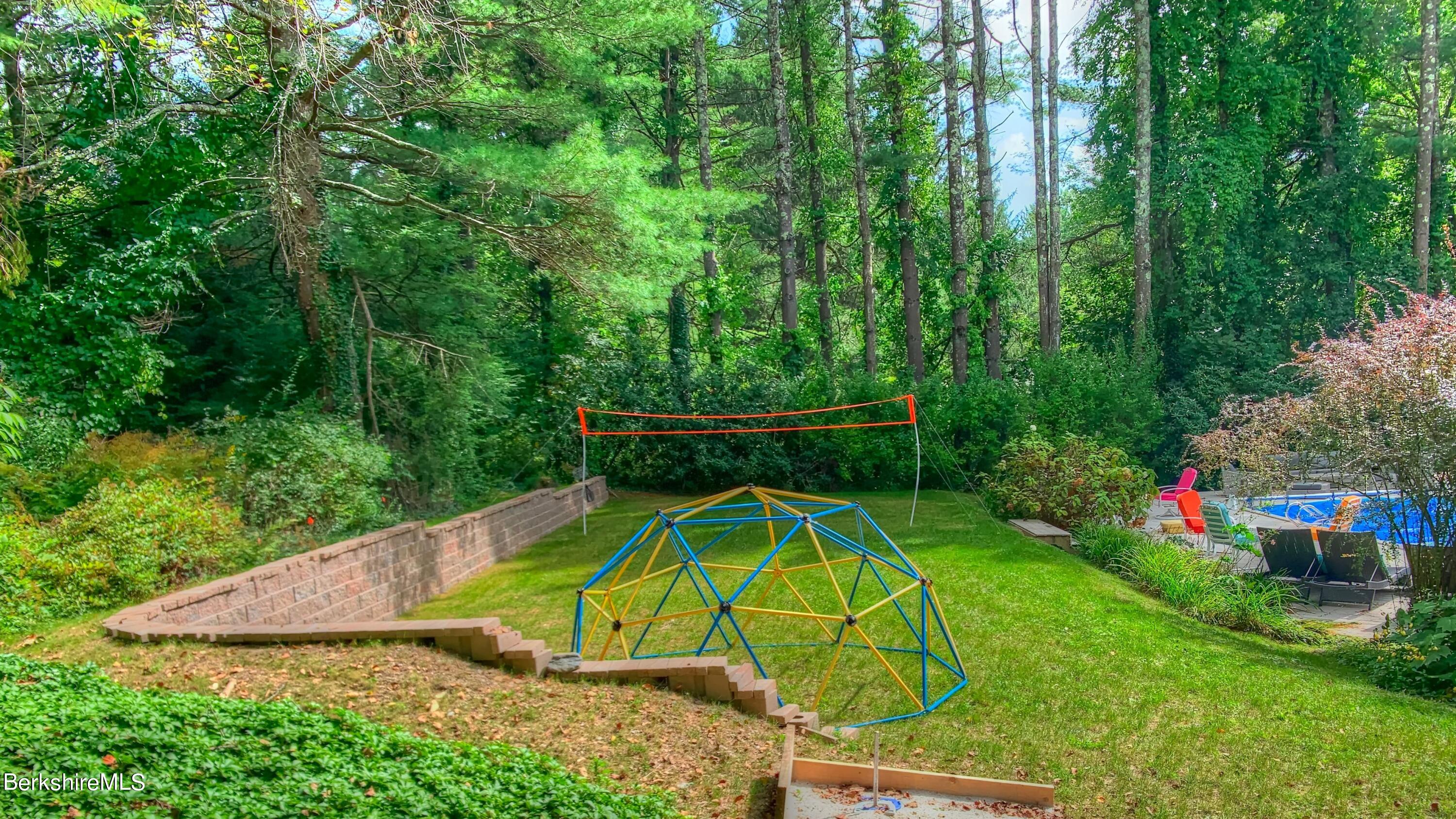 7 Hawthorne Road Stockbridge, MA 01262 - Photo 12 of 41 a view of a backyard with plants and swimming pool