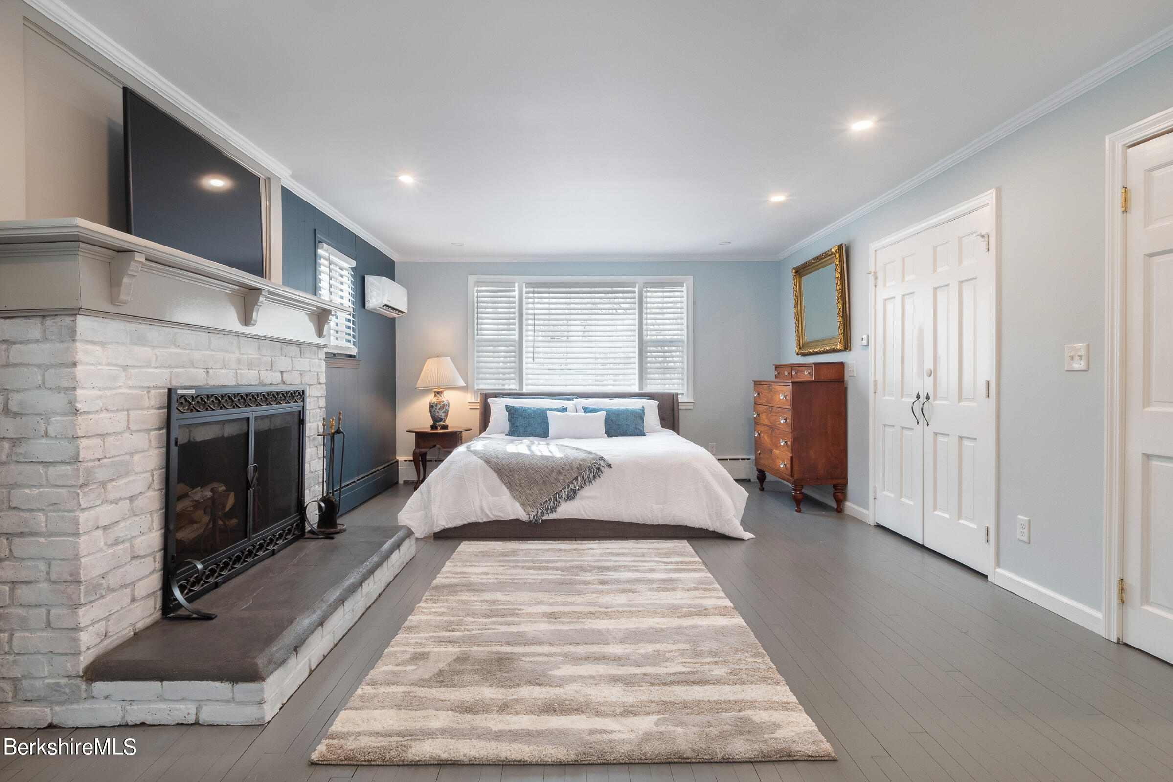 7 Hawthorne Road Stockbridge, MA 01262 - Photo 22 of 41 a spacious bedroom with a large bed and a fireplace