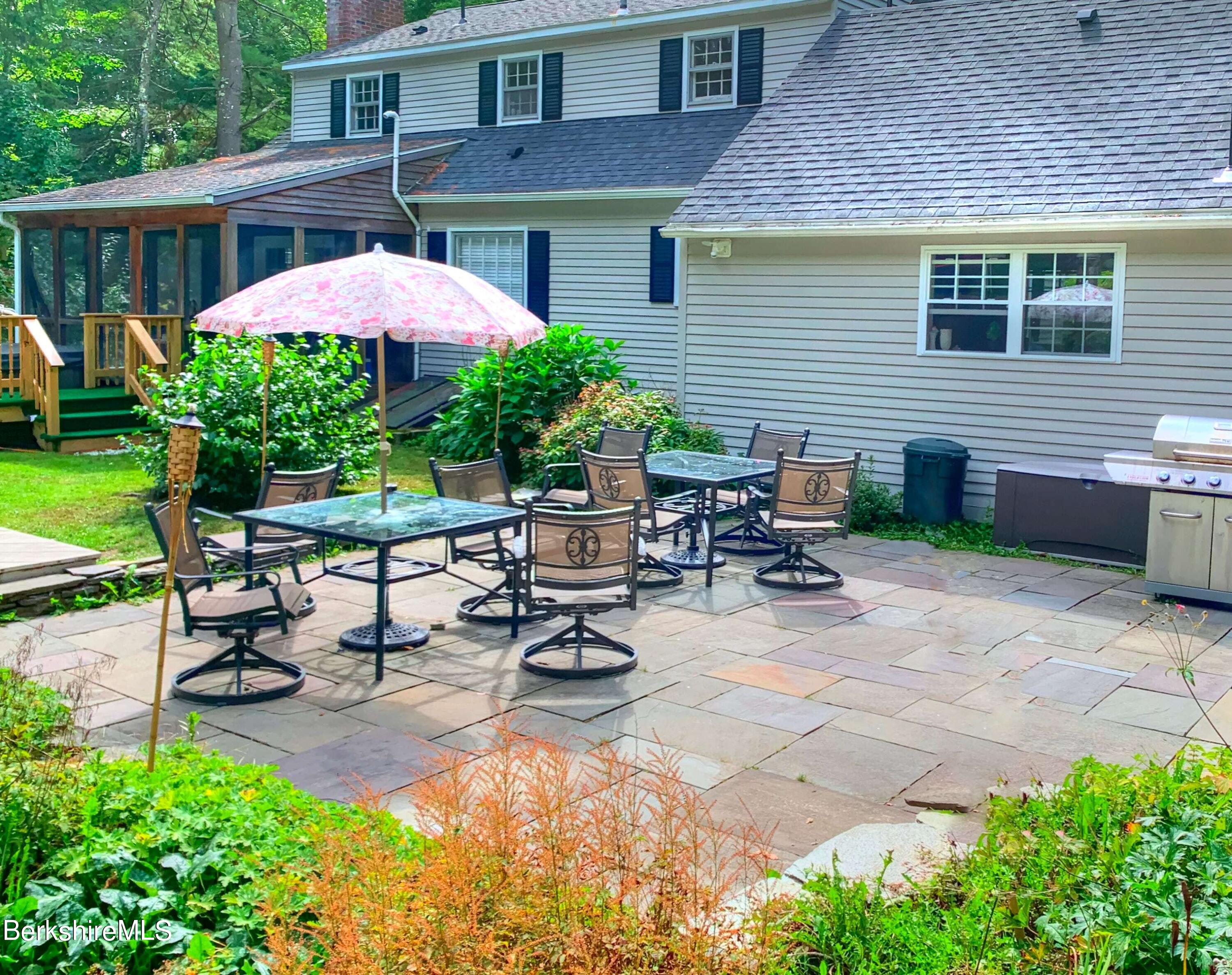 7 Hawthorne Road Stockbridge, MA 01262 - Photo 6 of 41 a view of a patio with table and chairs under an umbrella