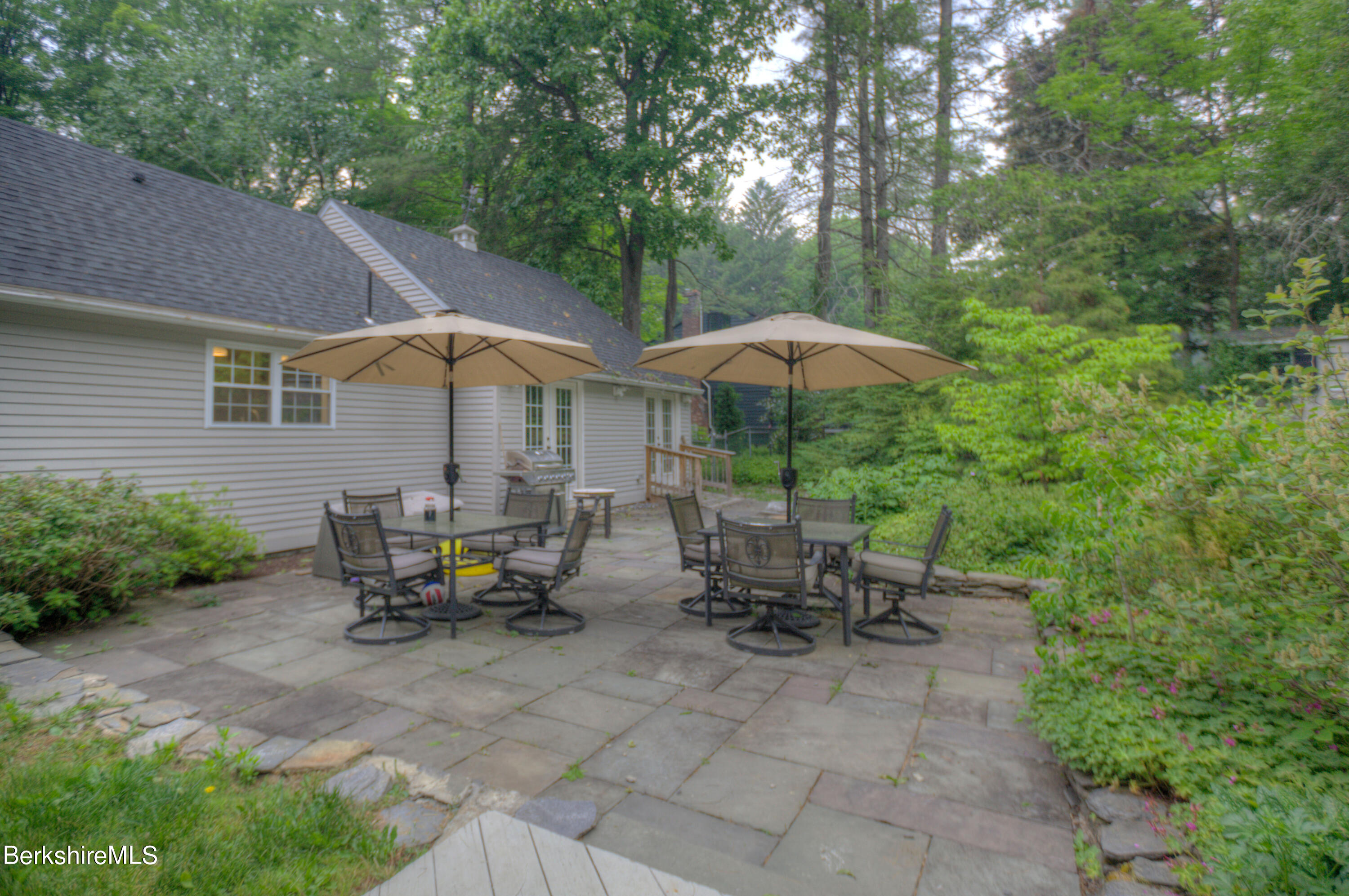 7 Hawthorne Road Stockbridge, MA 01262 - Photo 10 of 41 a view of patio with chairs and table under an umbrella