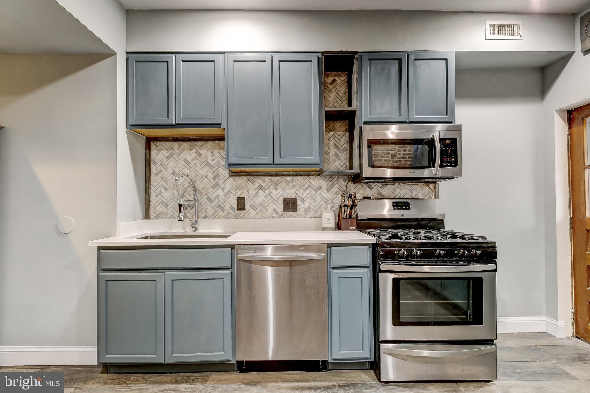 1404 Decatur Street Baltimore, MD 21230 - Photo 11 of 29 a kitchen with cabinets appliances and a sink