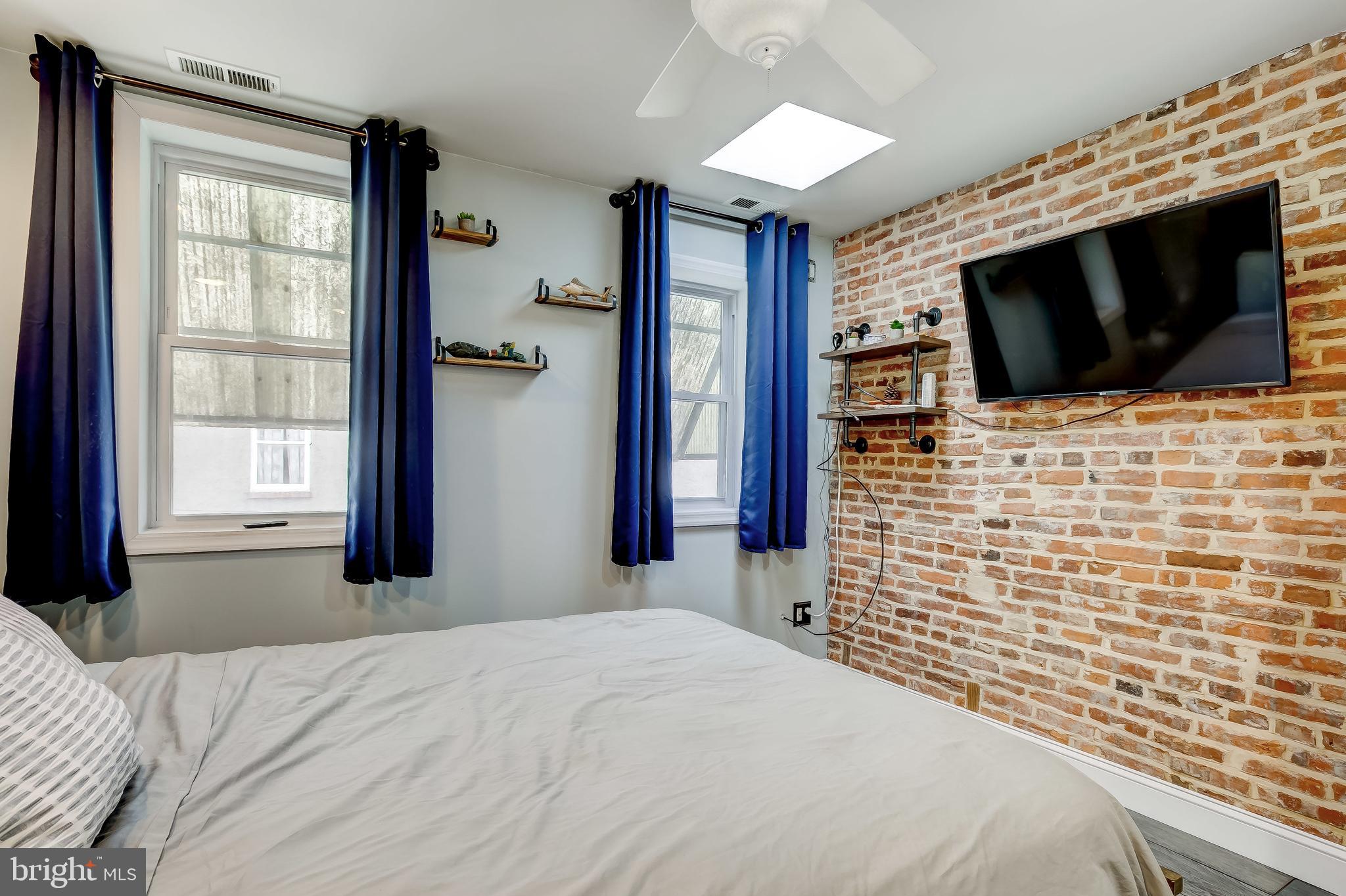 1404 Decatur Street Baltimore, MD 21230 - Photo 16 of 29 a bedroom with a bed and a flat screen tv