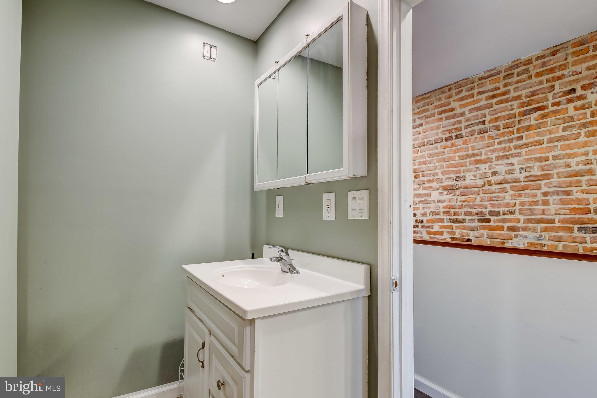 1404 Decatur Street Baltimore, MD 21230 - Photo 18 of 29 a bathroom with a sink and a mirror