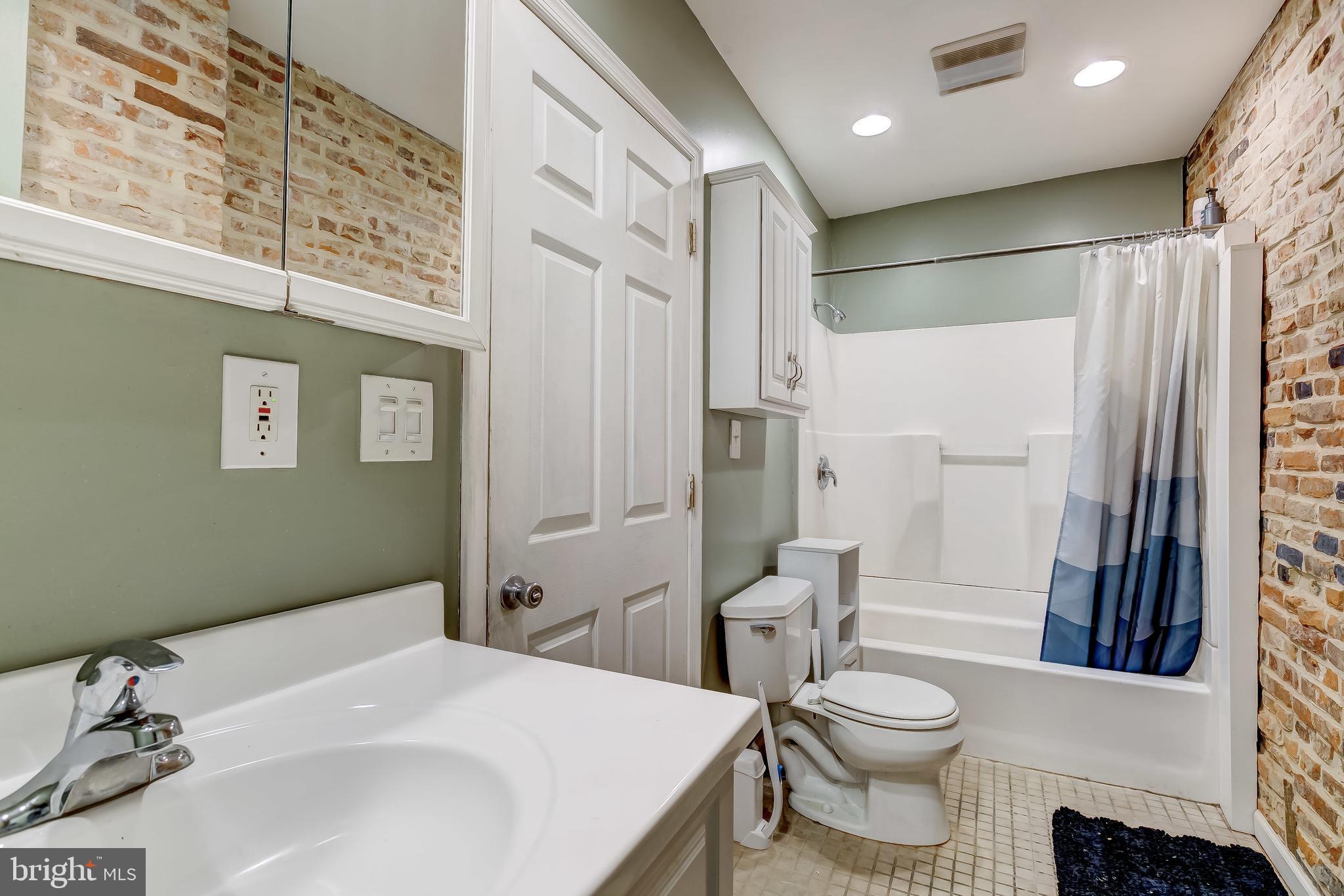 1404 Decatur Street Baltimore, MD 21230 - Photo 19 of 29 a bathroom with a sink toilet and shower