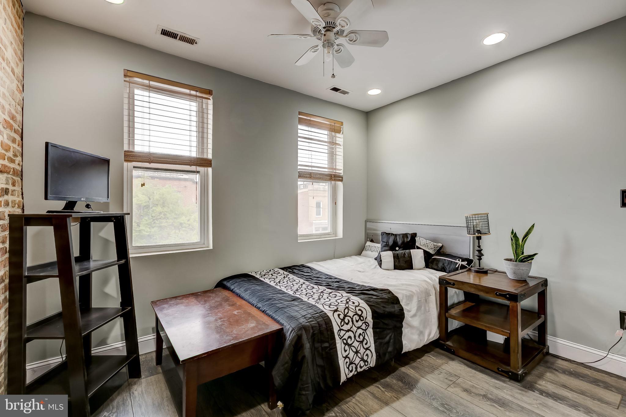1404 Decatur Street Baltimore, MD 21230 - Photo 21 of 29 a bedroom with a bed and a chandelier