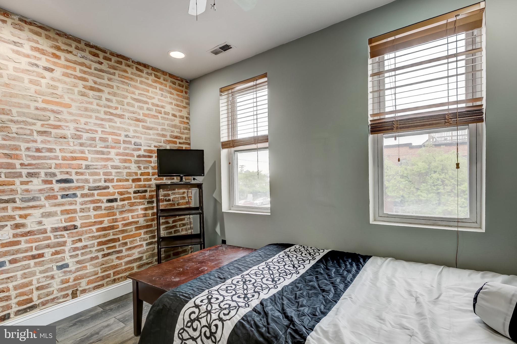 1404 Decatur Street Baltimore, MD 21230 - Photo 22 of 29 a bedroom with a bed and a flat screen tv