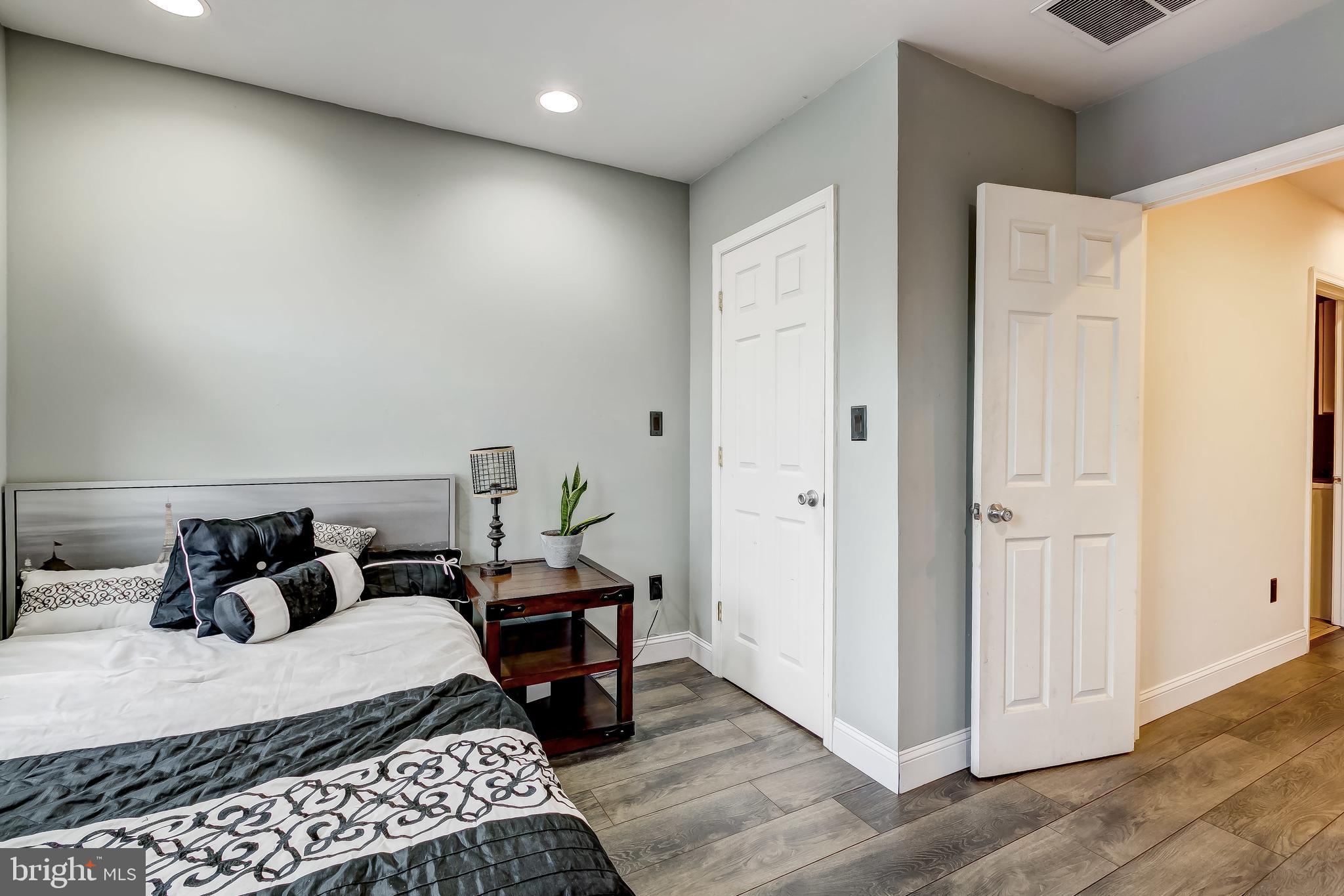 1404 Decatur Street Baltimore, MD 21230 - Photo 23 of 29 a bedroom with bed and wooden floor