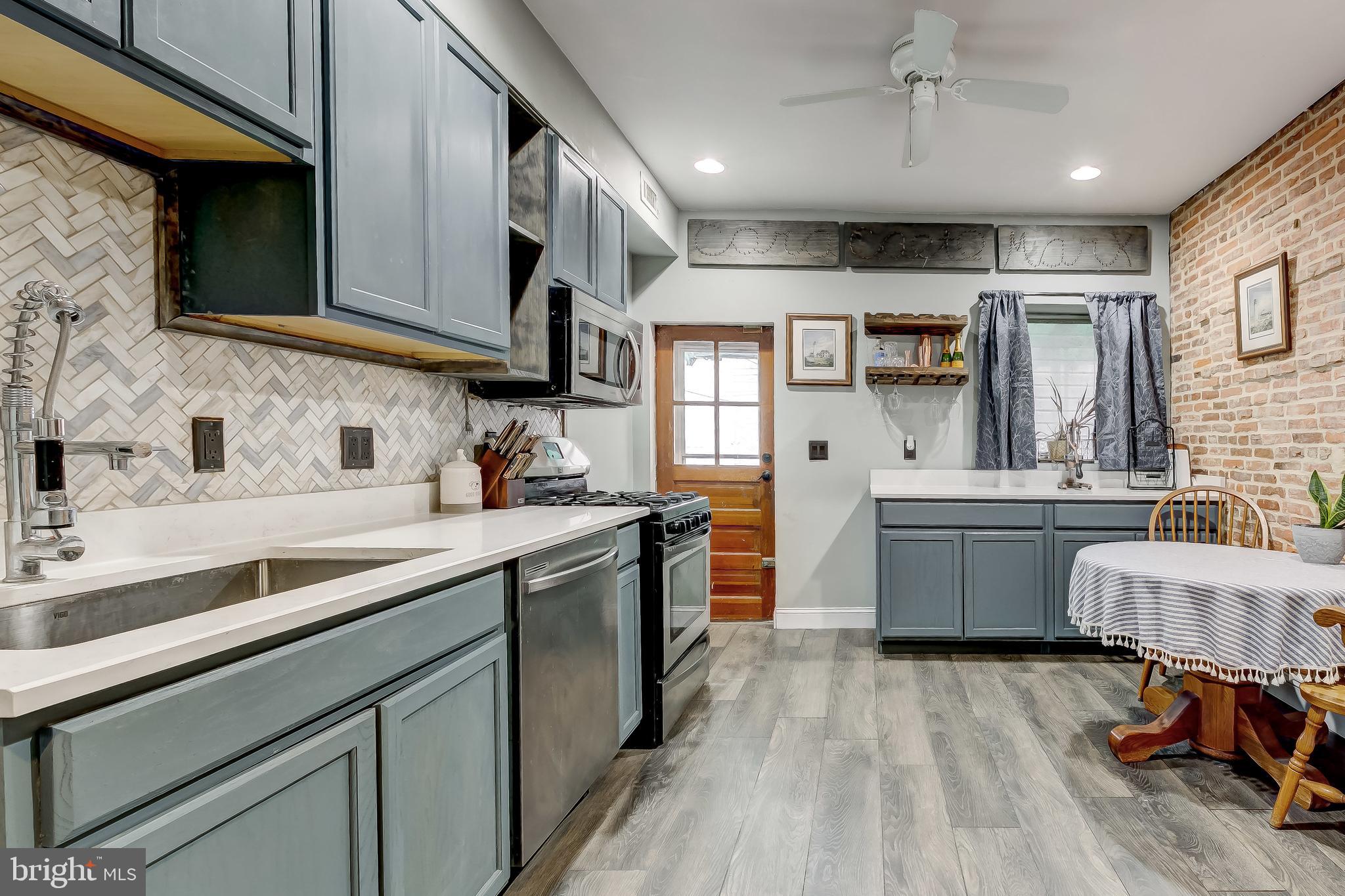 1404 Decatur Street Baltimore, MD 21230 - Photo 8 of 29 a kitchen with a sink cabinets and wooden floor