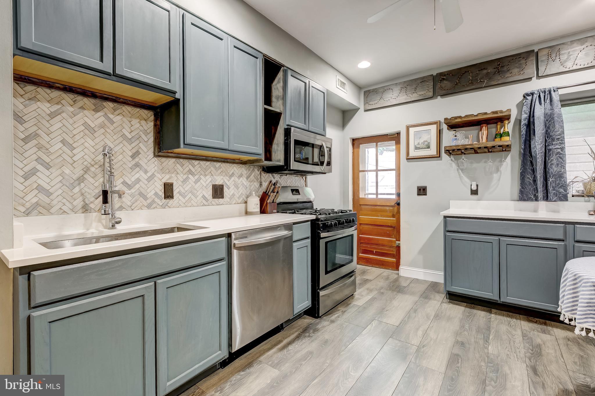 1404 Decatur Street Baltimore, MD 21230 - Photo 9 of 29 a kitchen with stainless steel appliances granite countertop a sink and cabinets