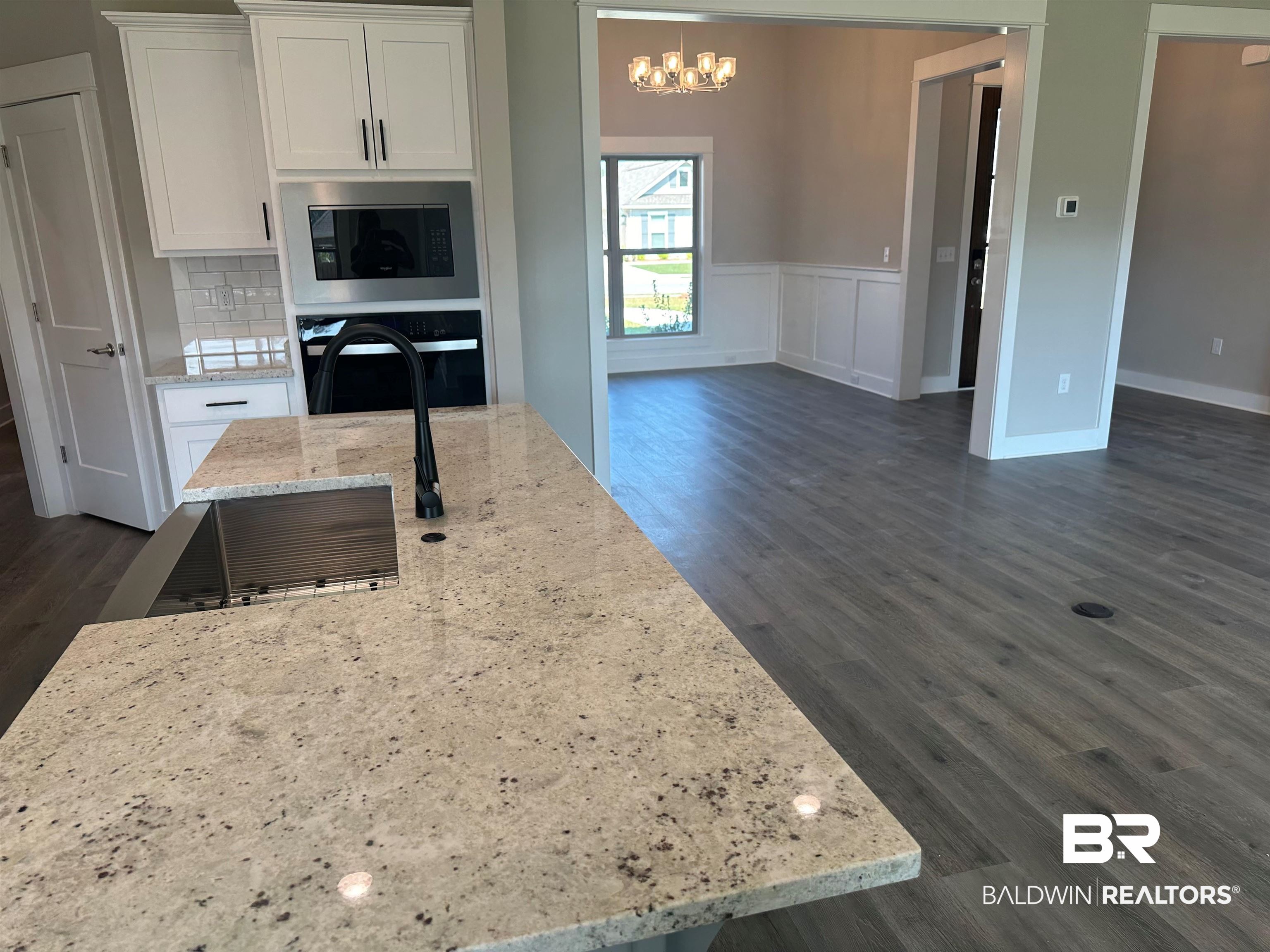 23548 Travis Stock Street, Unit 50 Foley, AL 36535 - Photo 11 of 30 Kitchen featuring oven, white cabinets, backsplash, dark hardwood / wood-style flooring, and light stone counters