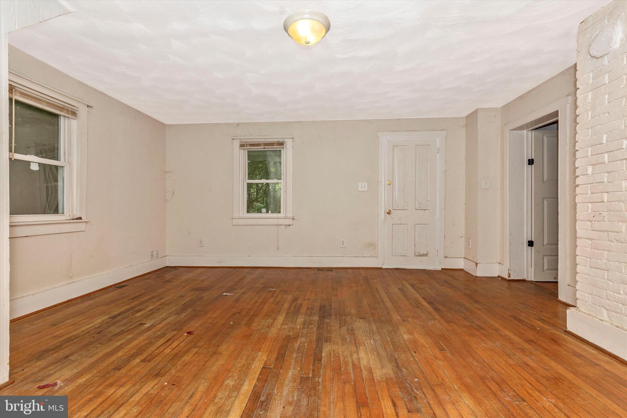 6300 Old Bohn Road Mount Airy, MD 21771 - Photo 25 of 45 a view of an empty room with wooden floor and a window
