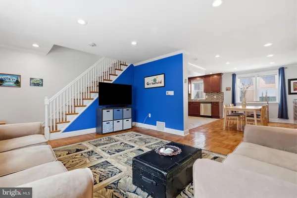 a living room with furniture pool table and a flat screen tv