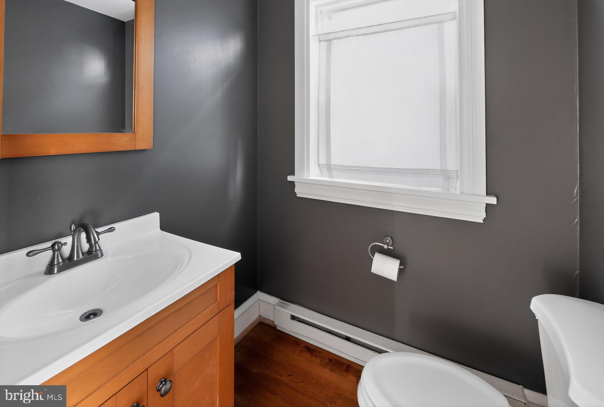 26 Waterloo Avenue Berwyn, PA 19312 - Photo 12 of 31 a bathroom with a toilet a sink and mirror