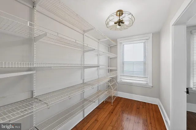 a view of a room with wooden floor and a window