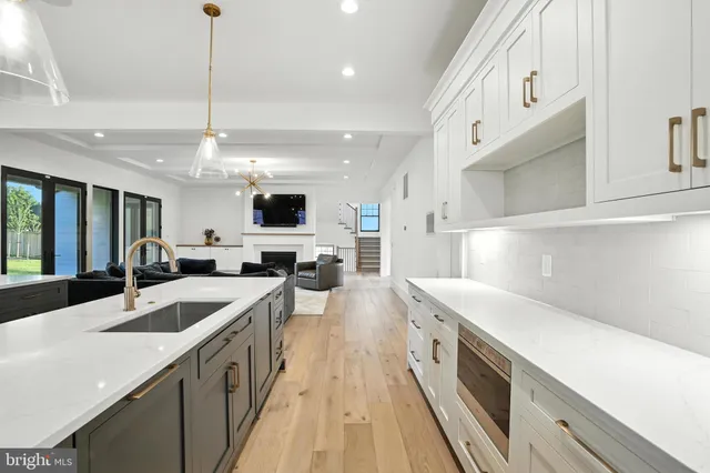 a kitchen with stainless steel appliances kitchen island granite countertop a table and chairs in it