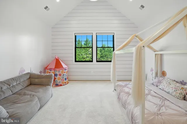 a living room with furniture and large window