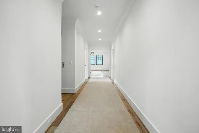 a view of an empty room with window and cabinet
