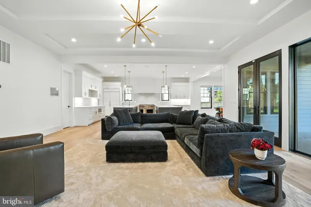 a large kitchen with stainless steel appliances kitchen island granite countertop a sink a counter space and wooden floor