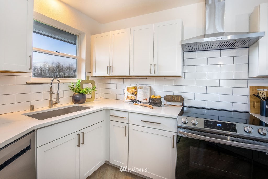 12425 Highway 12 Rochester, WA 98579 - Photo 11 of 29 a kitchen with a sink stove and cabinets