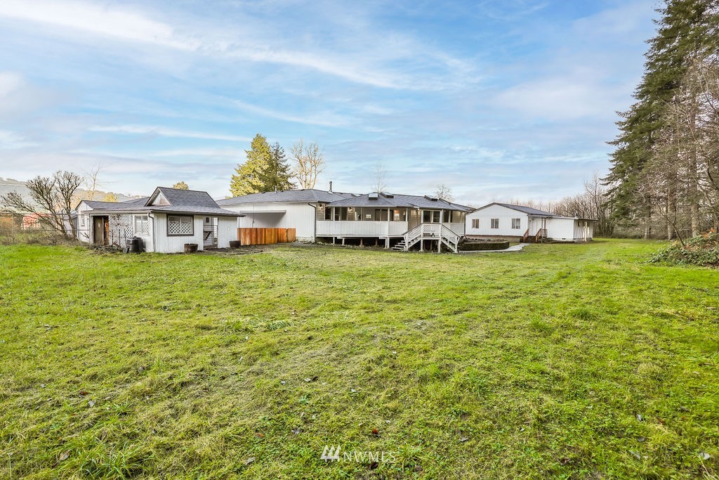 12425 Highway 12 Rochester, WA 98579 - Photo 24 of 29 a view of a house with a big yard and large trees