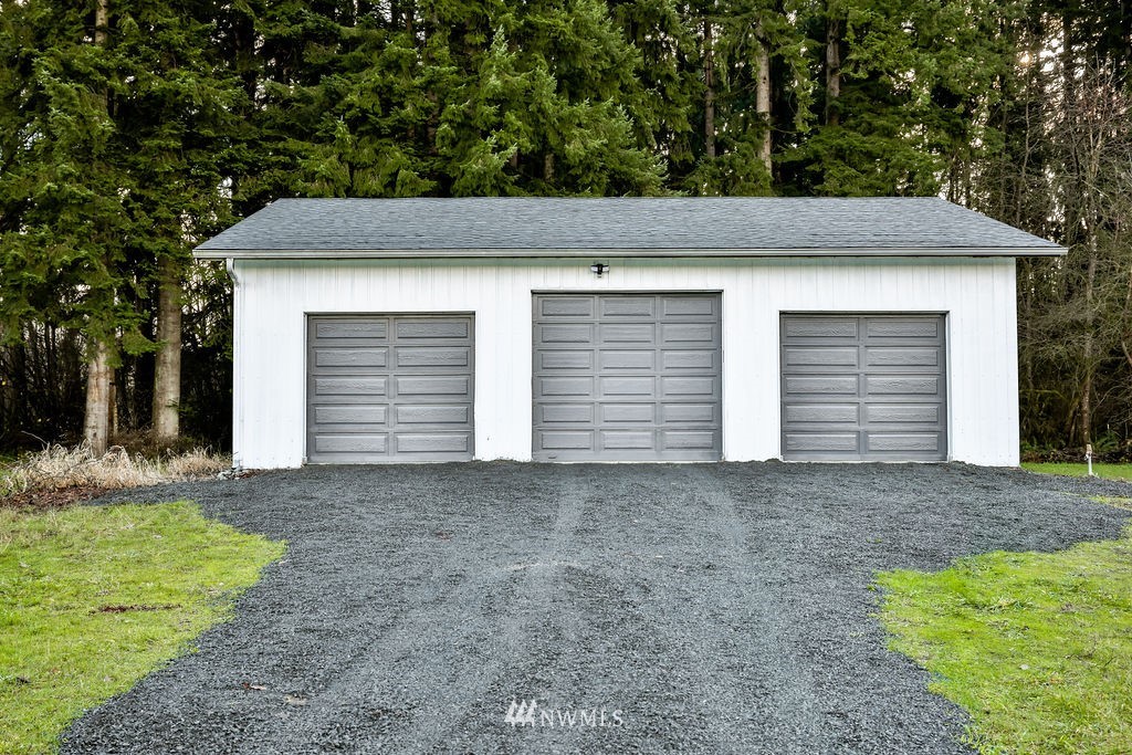 12425 Highway 12 Rochester, WA 98579 - Photo 26 of 29 a front view of a house with a yard and garage