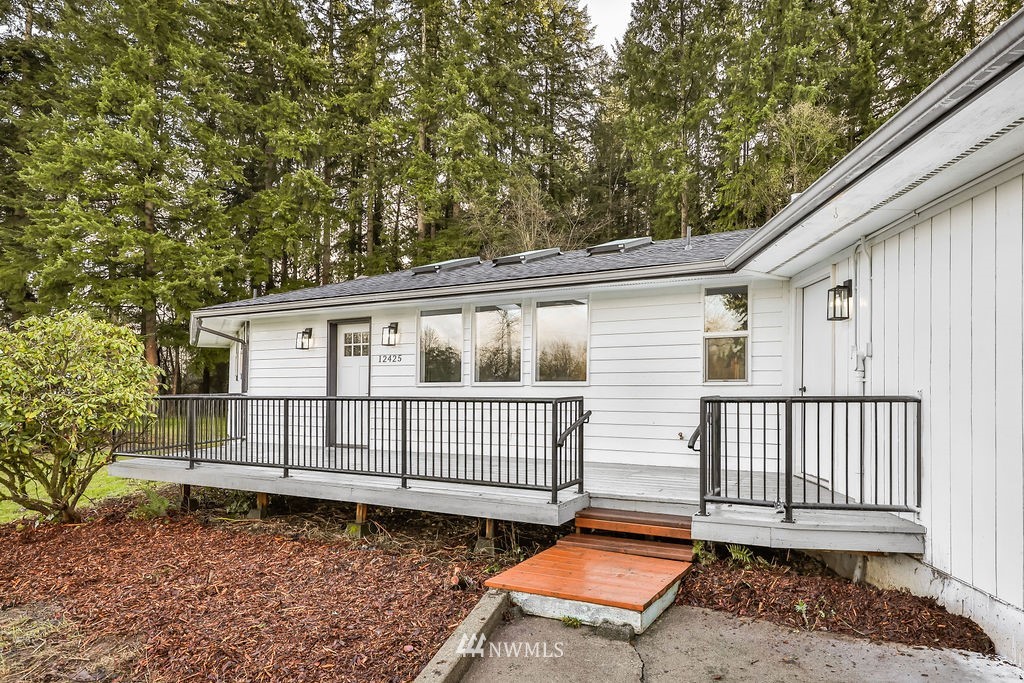12425 Highway 12 Rochester, WA 98579 - Photo 6 of 29 a view of a small house with wooden floor in front of it