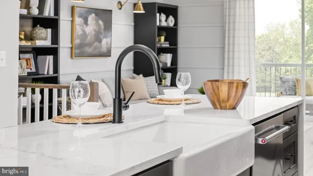 a kitchen with a sink a stove and a dining table