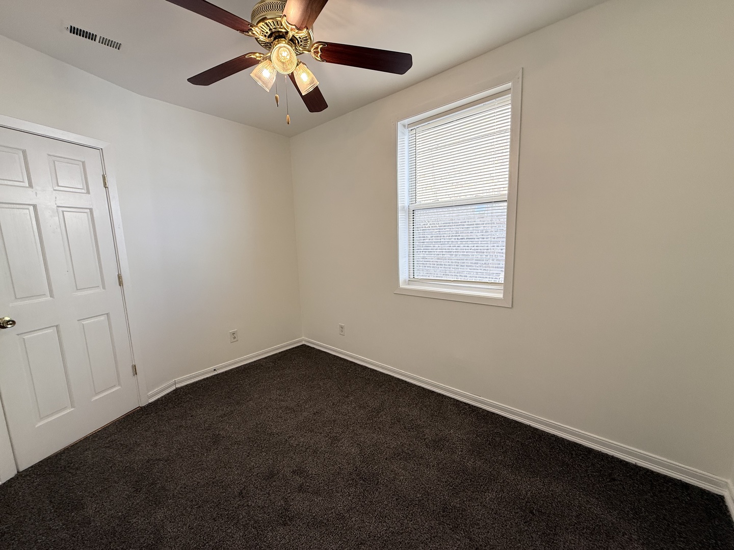 3643 South Hamilton Avenue, Unit 3 Chicago, IL 60609 - Photo 15 of 29 an empty room with a window and a fan