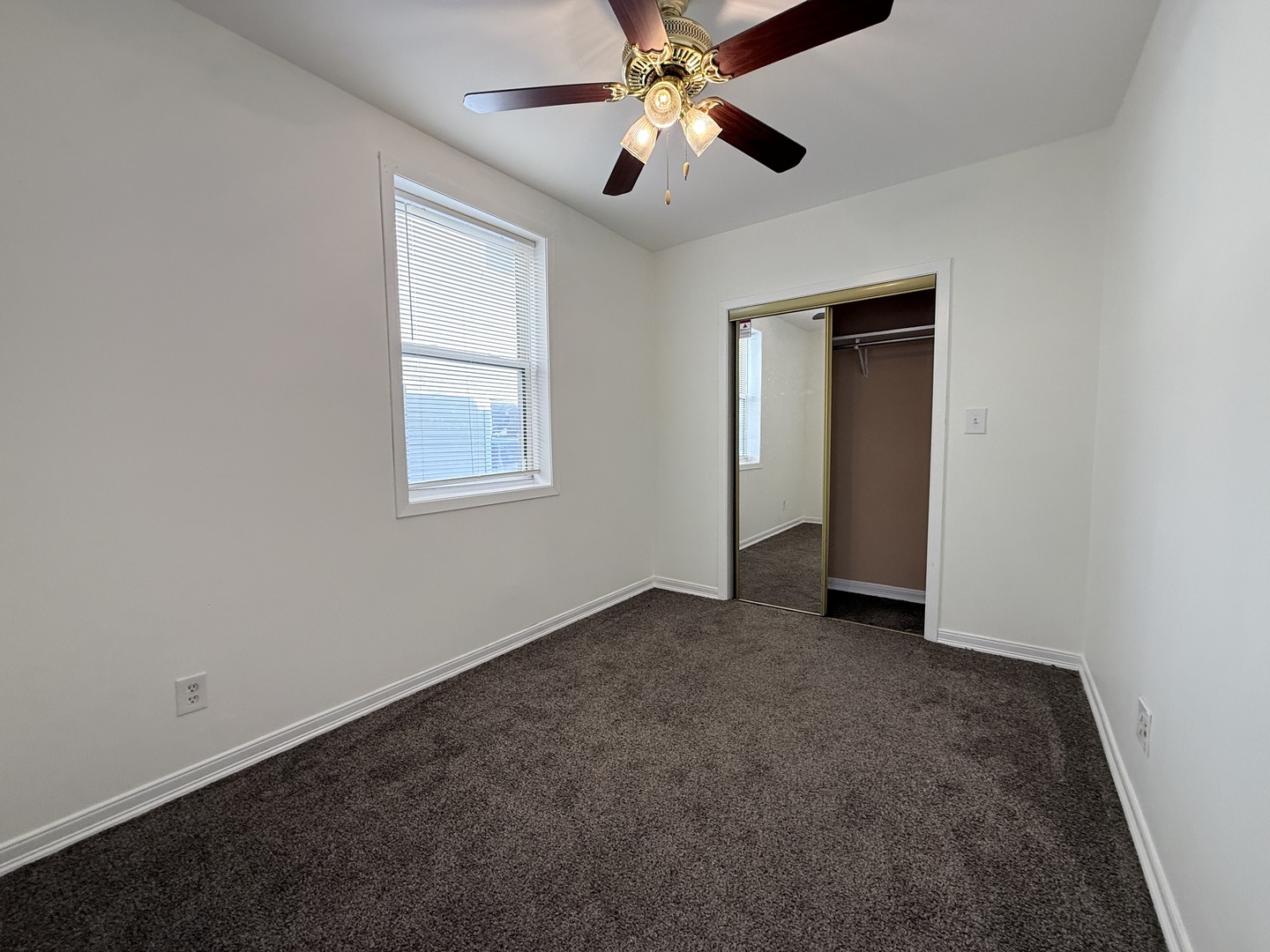 3643 South Hamilton Avenue, Unit 3 Chicago, IL 60609 - Photo 17 of 29 an empty room with windows and fan