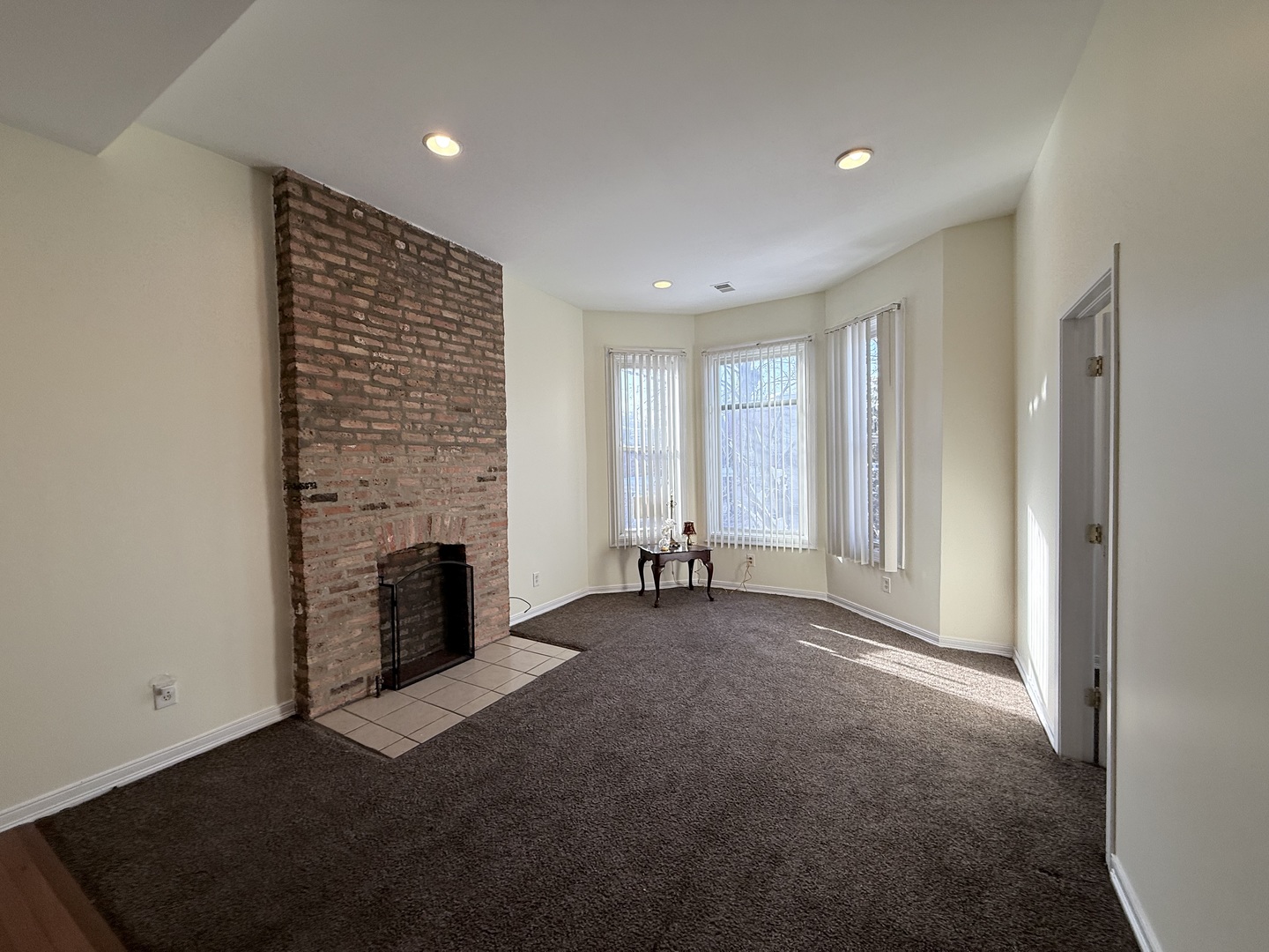 3643 South Hamilton Avenue, Unit 3 Chicago, IL 60609 - Photo 3 of 29 an empty room with fireplace and windows