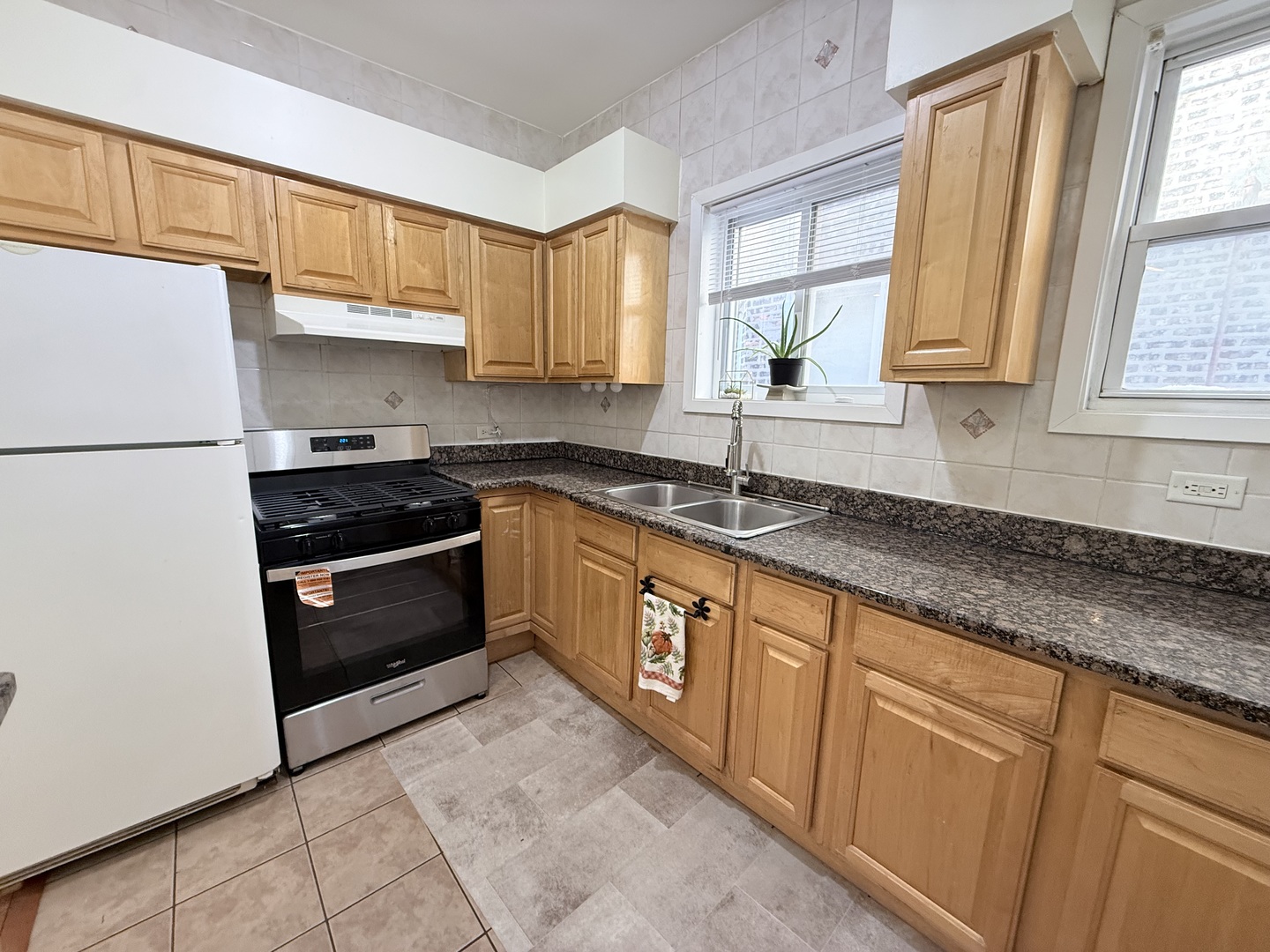 3643 South Hamilton Avenue, Unit 3 Chicago, IL 60609 - Photo 9 of 29 a kitchen with stainless steel appliances granite countertop a sink stove and refrigerator