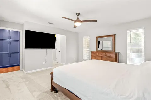 a bedroom with a bed and a flat screen tv