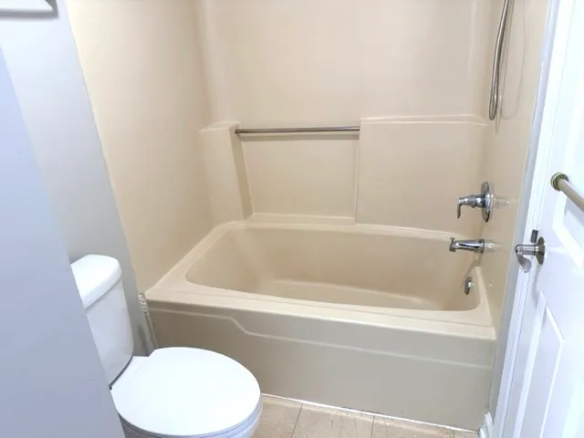 a bathroom with a toilet and bathtub