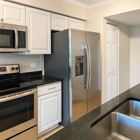 a kitchen with stainless steel appliances a refrigerator stove and microwave
