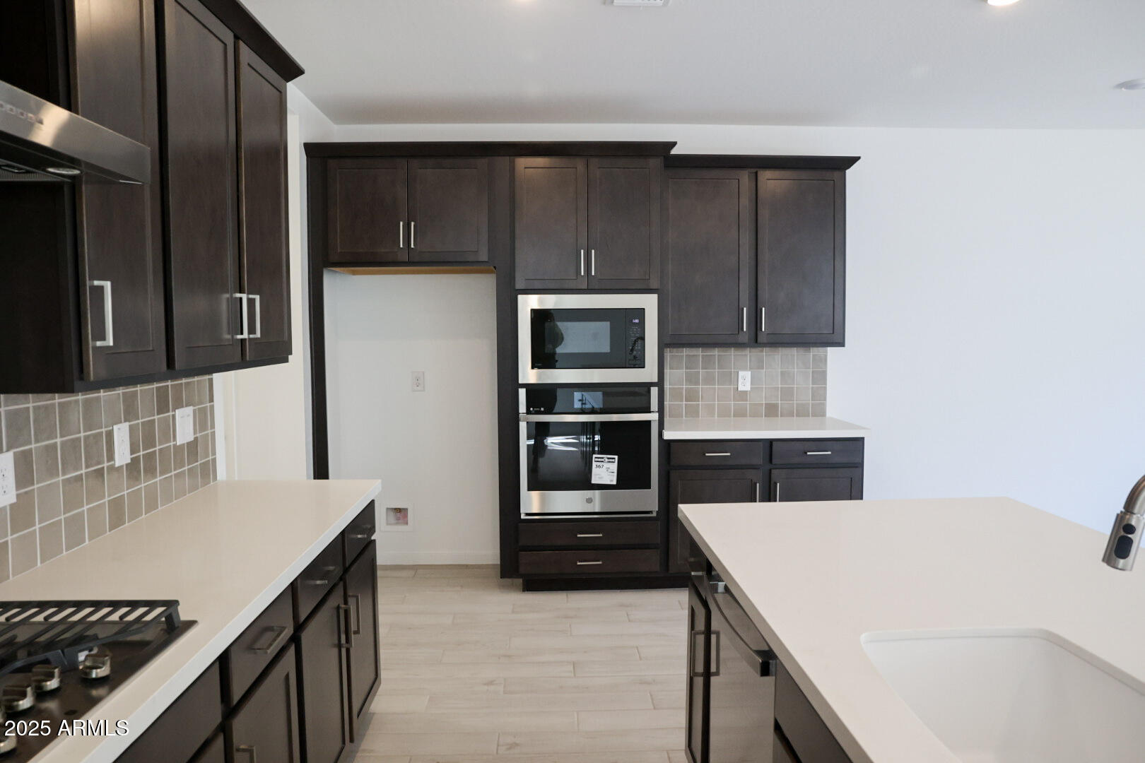 2460 West Rowel Road Phoenix, AZ 85085 - Photo 4 of 25 a kitchen with a sink and a stove top oven