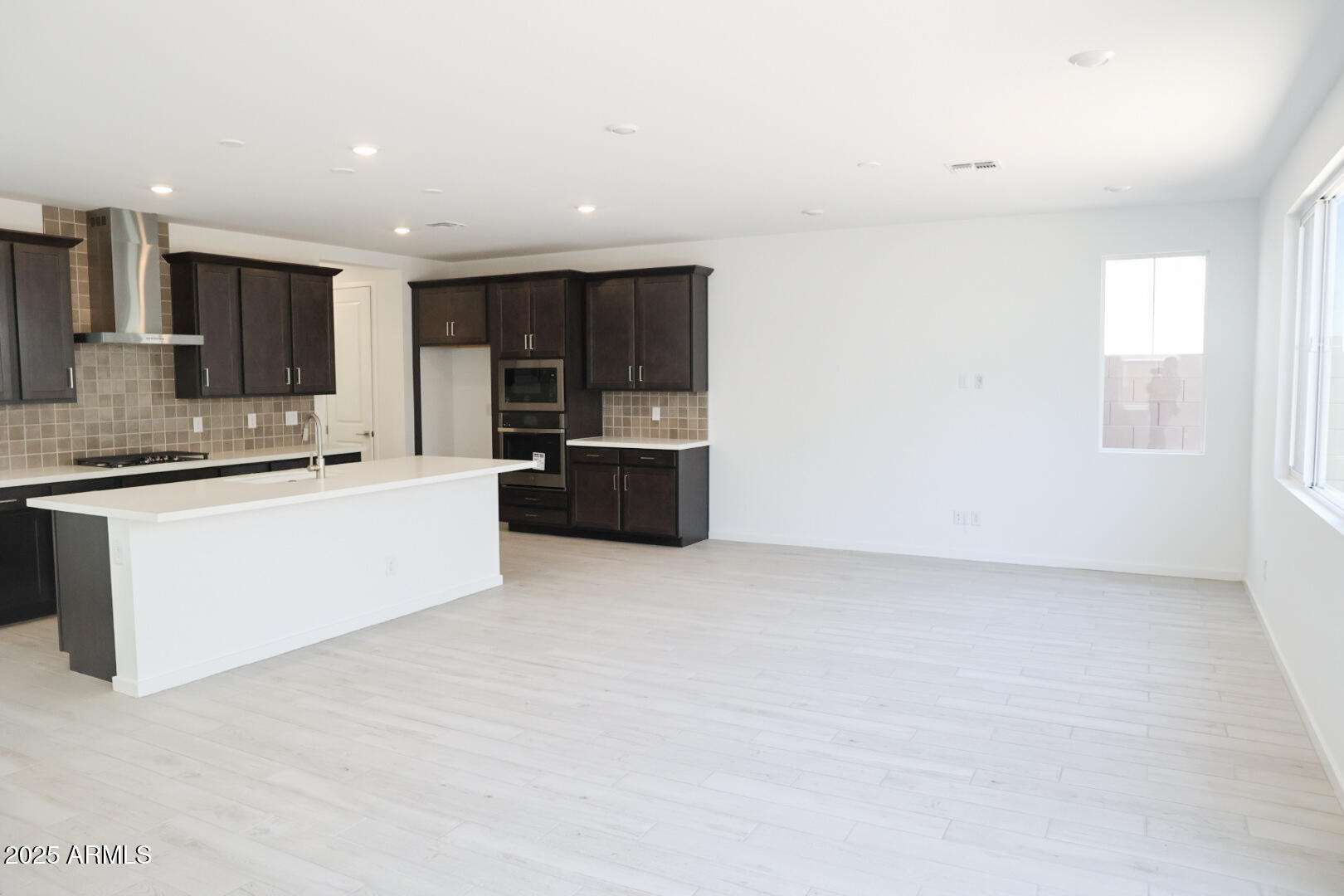 2460 West Rowel Road Phoenix, AZ 85085 - Photo 5 of 25 a large white kitchen with a stove a sink and a microwave