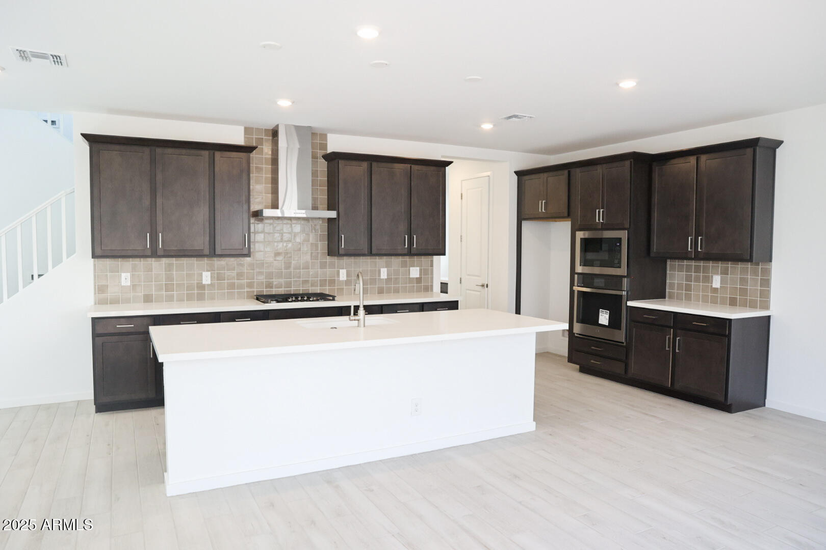 2460 West Rowel Road Phoenix, AZ 85085 - Photo 6 of 25 a large kitchen with stainless steel appliances granite countertop a stove a refrigerator a sink and dishwasher with wooden floor